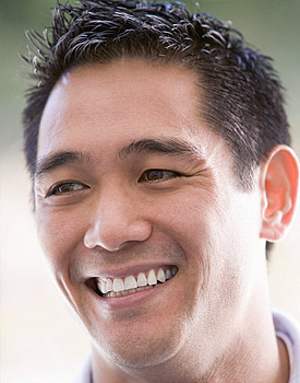 photo of a smiling man - reaping the benefits of successful cosmetic dentistry