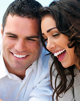 photo of a smiling young couple - both with great smiles and healthy teeth